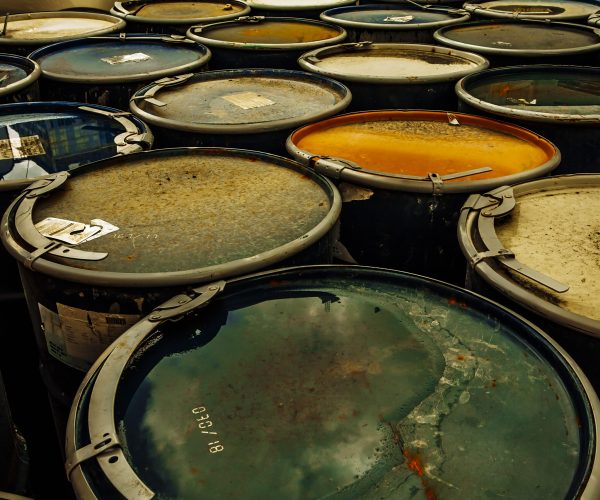 Photo of a group of rusting metal drums.